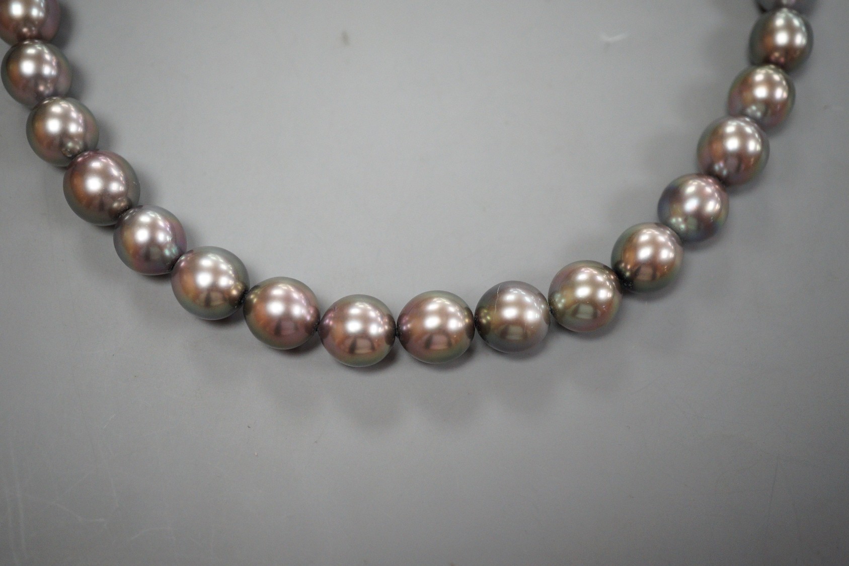 A single strand Tahitian style South Sea pearl necklace, with 585 brushed yellow metal clasp, retailed by Musson